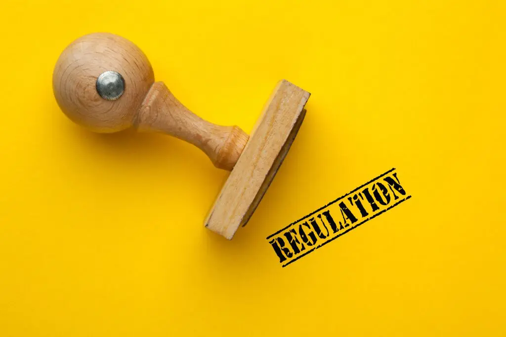 regulationwordwithwoodenrubberstamp-lawrulesandregulations